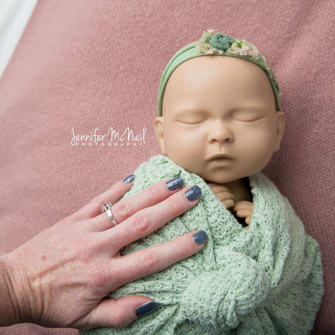 newborn baby girl with green eyes and brown hair